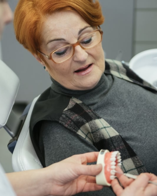 denture patient looking at dentures