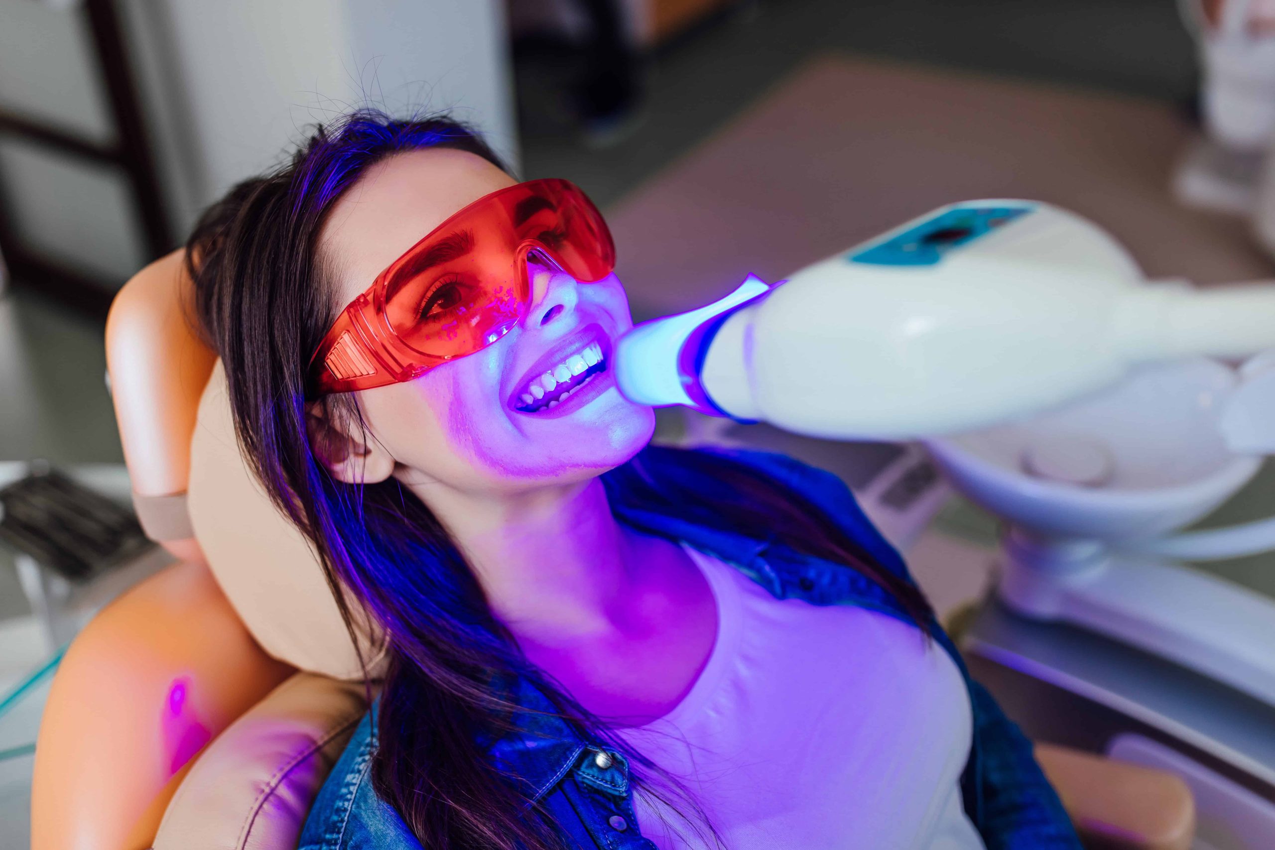 Professional teeth whitening treatment using a dental whitening light